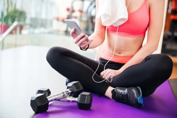 Woman on phone at gym