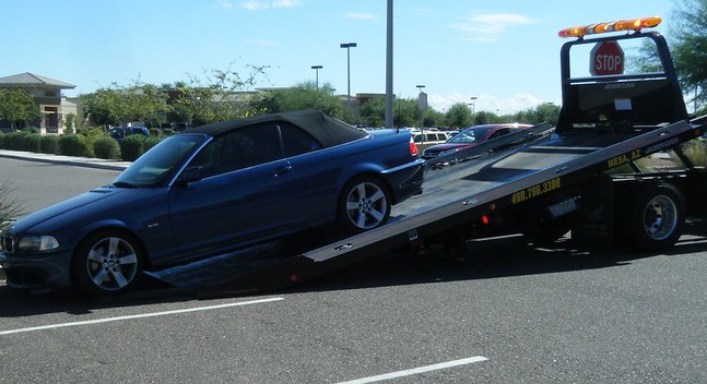 BMW towed on flat bed truck